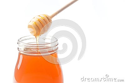 Jar of honey with wooden drizzler Stock Photo