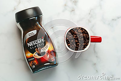 Jar of Nescafe Classic and red cup of Nescafe with coffee beans Editorial Stock Photo