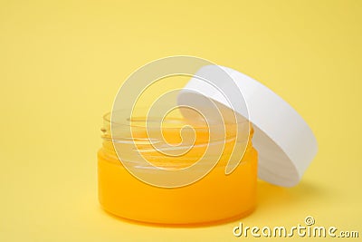 Open jar of petrolatum on yellow background Stock Photo