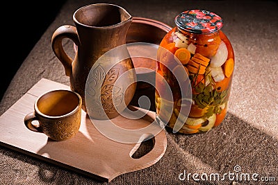 Jar of Pickles on Table with Wooden Handicrafts Stock Photo