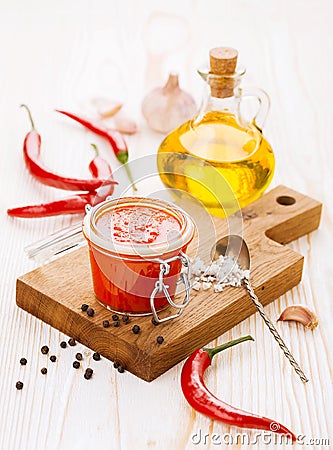 Jar of piquant sauce made from chili peppers and garlic Stock Photo