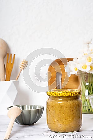 Jar with propolis honey on kitchen table still life. Healthy sweet food Stock Photo