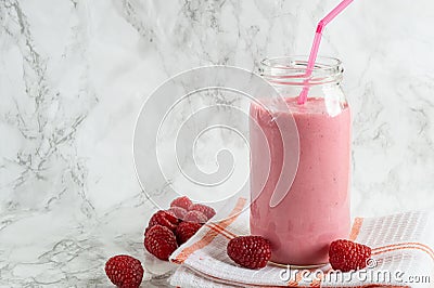 Jar with rasberry smoothie and fresh rasberry on tawel on white background Stock Photo