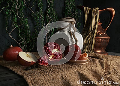 jar, rop, apples,pomegranate,plant and orange on canvas drapery conceptual still-life Stock Photo