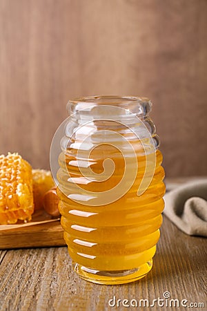 Jar of tasty aromatic honey on wooden table Stock Photo