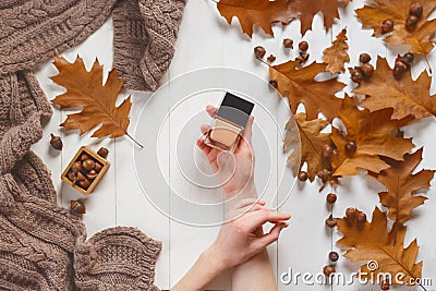 Jar with a tonal cream in the hands of a girl. Top view. Natural beauty cosmetics concept. Autumn beauty Stock Photo