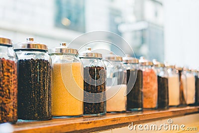 Jars of coffee beans, instant coffee, sugar, and ingredients in vintage tone, depth of field effect, with copy space Stock Photo