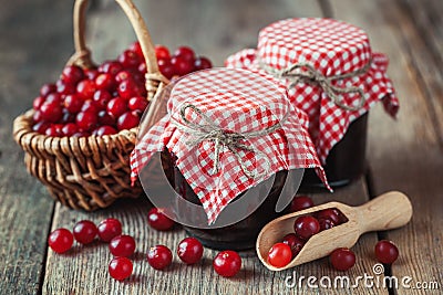 Jars of cranberries jam and basket with bog berry Stock Photo