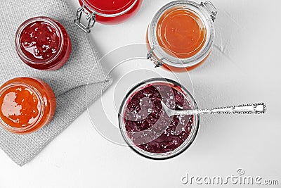 Jars with different sweet jam on table Stock Photo