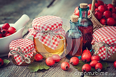 Jars of honey, tincture bottles and mortar of hawthorn berries Stock Photo