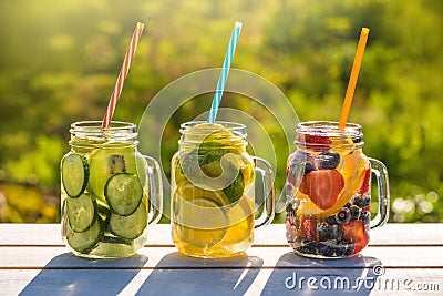 Mason jars of infused water with fruits Stock Photo