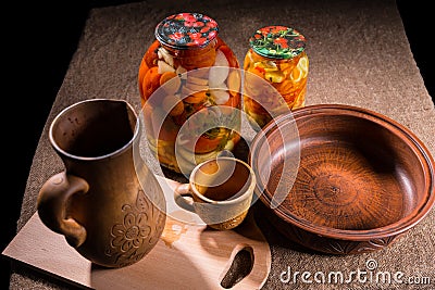 Jars of Pickles on Table with Wooden Handicrafts Stock Photo