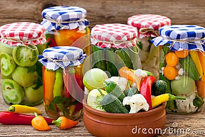 Jars with pickles, tomatoes and chillies Stock Photo