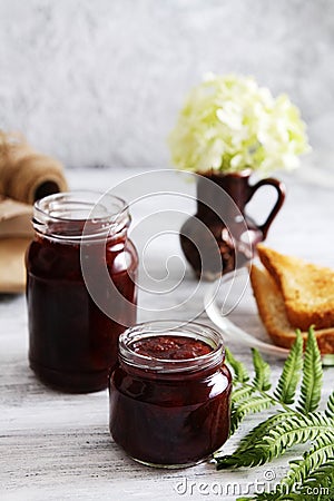 jars of strawberry jam and toasts. Sweet food Stock Photo