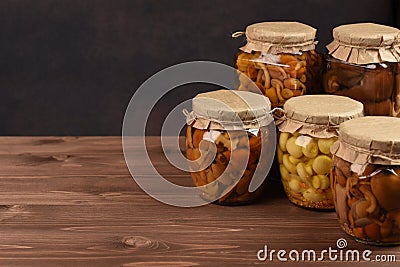 Variety of mushrooms marinated mushrooms in glass jars. Stock Photo