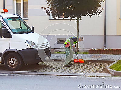 Jaslo, Poland - may 25 2018:An employee of the municipal service of the city removes the territory. Refinement of the area around Editorial Stock Photo