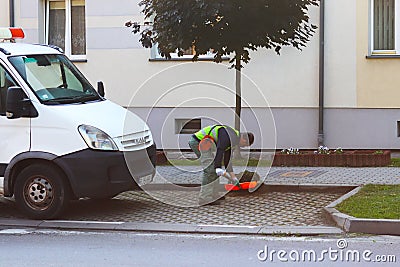 Jaslo, Poland - may 25 2018:An employee of the municipal service of the city removes the territory. Refinement of the area around Editorial Stock Photo