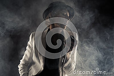 Jazz singer woman with retro microphone in smoke Stock Photo