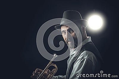 Jazz trumpet player on a dark background Stock Photo