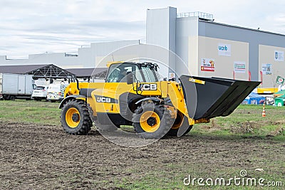 The JCB bucket loader, Tractor at a demonstration site agro exhibition AgroExpo. Tractor rides on the field. Kropivnitskiy, Editorial Stock Photo