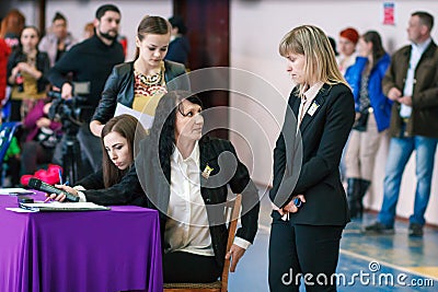 jChampionship of the city of Kamenskoye in cheerleading among solos, duets and teams, sports judges discuss the performance of ath Editorial Stock Photo