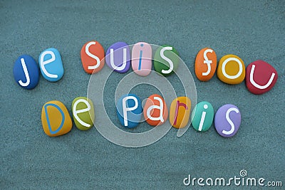 Je suis fou de Paris, I am crazy about Paris, creative slogan with stone colored letters over green sand Stock Photo