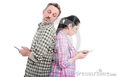 Jealous guy peeking to girlfriend phone Stock Photo