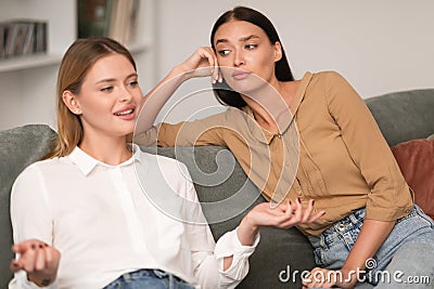 Jealous Woman Listening With Envy To Her Friend Bragging Indoors Stock Photo