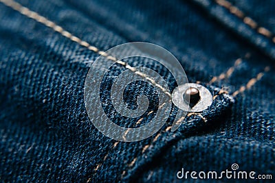 Jeans rivet on blue denim jeans with copy space Stock Photo