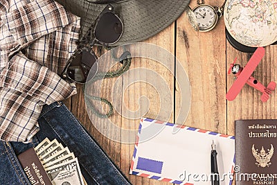 Jeans, shirt, passports, banknote, sunglasses, airplane model, pocket watch, fountain pen and envelope of cost of travel prepared Stock Photo