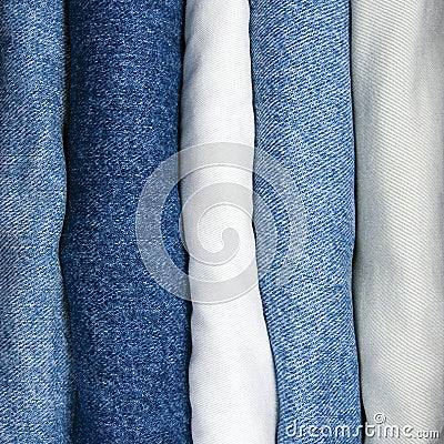 Jeans stack, detailed vertical macro closeup, blue indigo denim, khaki, white beige Stock Photo