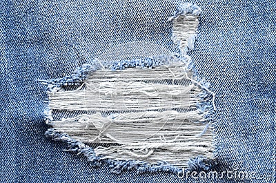 Jeans in wash blue with rip. Denim background, texture. Ripped d Stock Photo