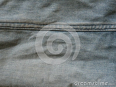 Jeans in wash blue with rip. Denim background, texture. Ripped. Organic, design. Stock Photo