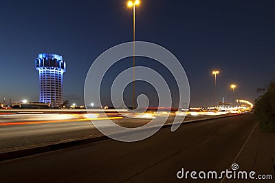 Jeddah water tower at night, with car lights motion on the street. Stock Photo