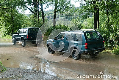 A jeep being towed by another car Stock Photo