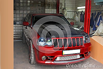 Kyiv, UA - September 4, 2012: Jeep Grand Cherokee SRT8 drives into the garage. Carbon hood Editorial Stock Photo