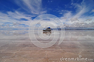 Jeep reflected in Salar de Uyuni Stock Photo