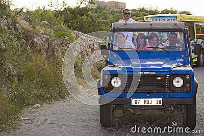 Jeep-safari - All-wheel drive car with tourists rides on the evening of Alanya Editorial Stock Photo