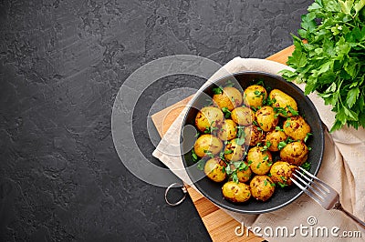 Jeera Aloo in black bowl on dark slate background. Jeera Aloo is indian cuisine dish Stock Photo