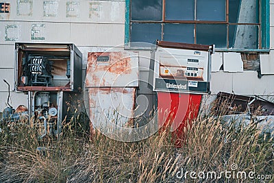 Abandoned gas station pumps next to a closed service station Editorial Stock Photo