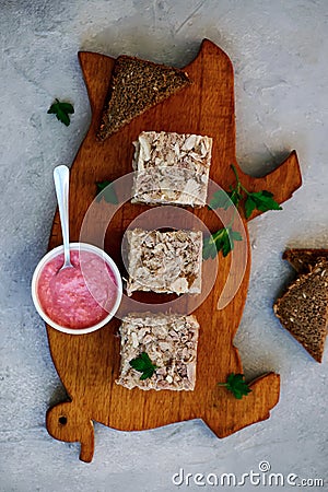 Jellied meat with horseradish on a wooden board.style hugge Stock Photo