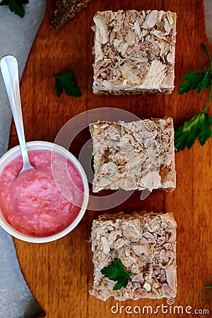 Jellied meat with horseradish on a wooden board.style hugge Stock Photo