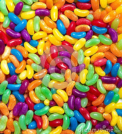 Jelly beans candies colourful rainbow wallpaper. Festive party background made of glucose sweets for confectionary store Stock Photo