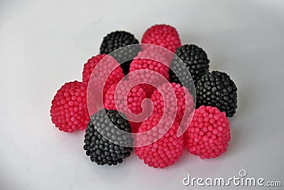 Jelly candies in the form of raspberries, red and black on a white background Stock Photo