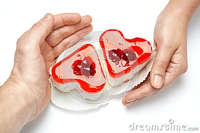 Jelly heart-shaped cakes in hands of lovers Stock Photo