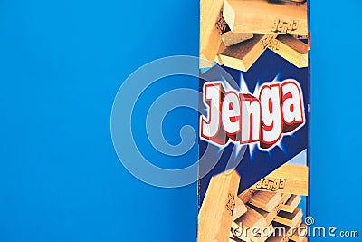 Jenga tower game - wood blocks on blue background Editorial Stock Photo