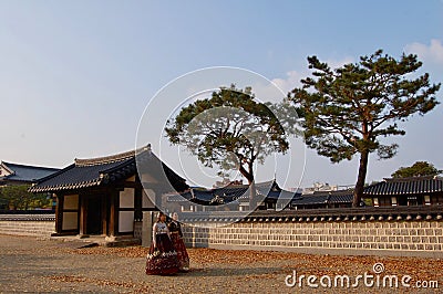 Jeonju Hanok Village, South Korea - 09.11.2018: Womans in hanbok dress inside of traditional palace. Editorial Stock Photo