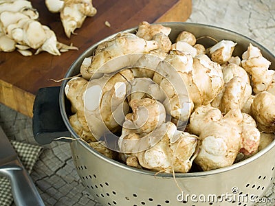 Jerusalem artichokes in a colander Stock Photo