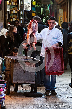 Jerusalem, December 2012: Young butcher trades meat in Jerusalem souk Editorial Stock Photo