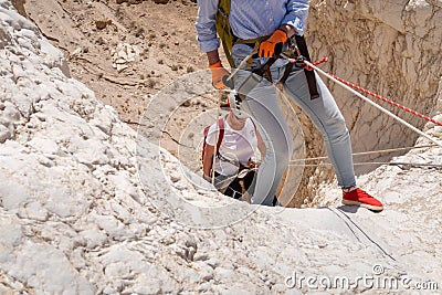 Experienced athletes start the descent with the equipment for snapping in the mountains of the Judean Desert near the Tamarim Editorial Stock Photo